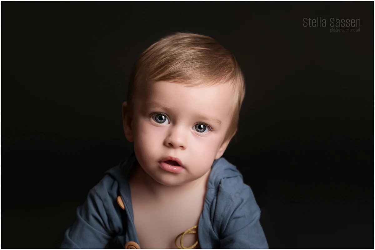 Close-up portrait of a little boy with beautiful blue eyes in a studio shoot